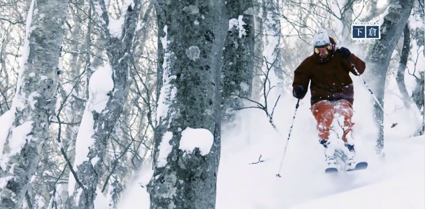 skier absolutely ripping through pow