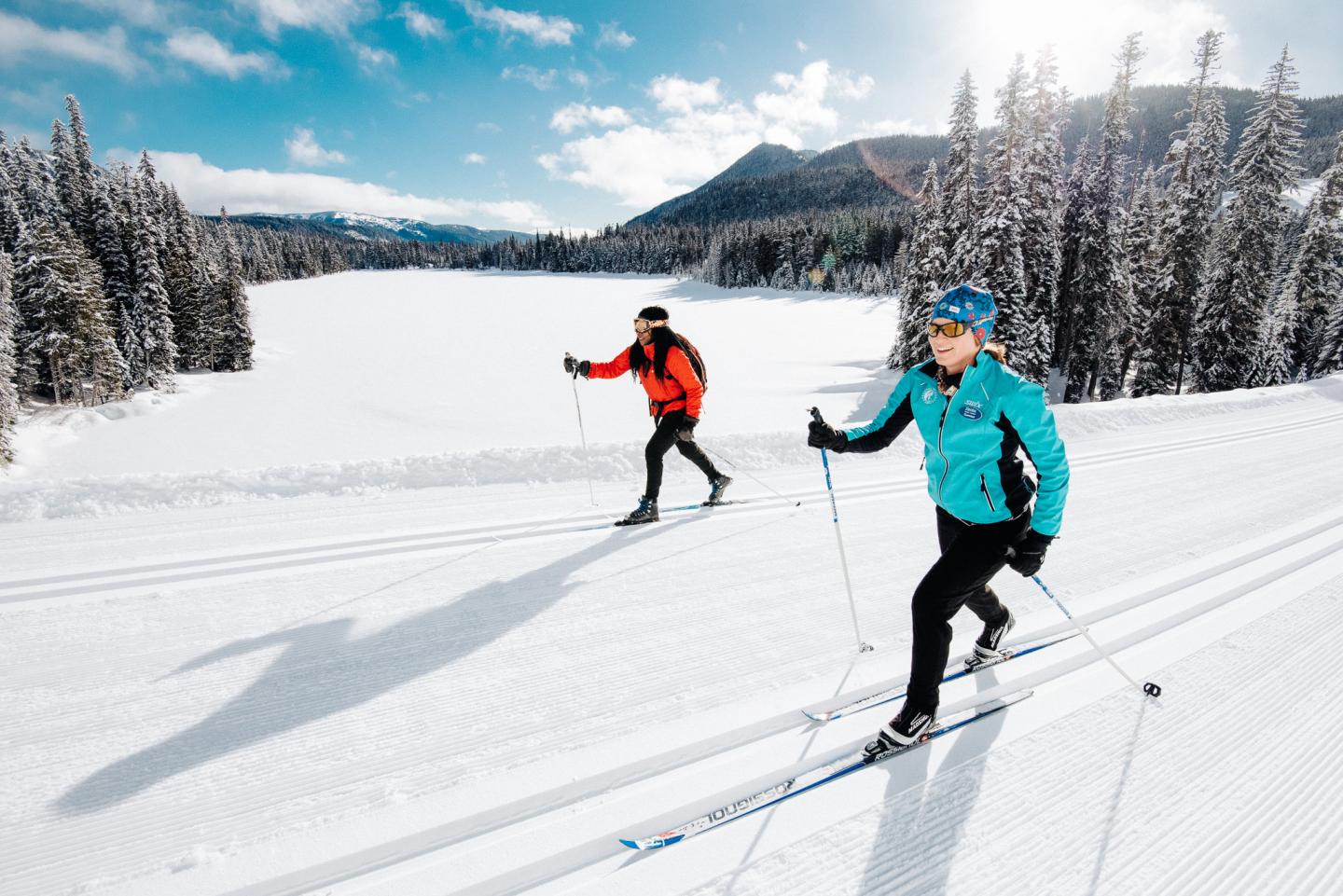 Two people cross country skiing