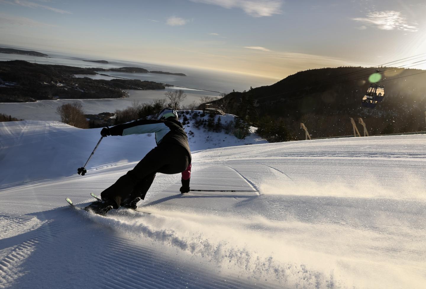 skier ripping cord during sunrise