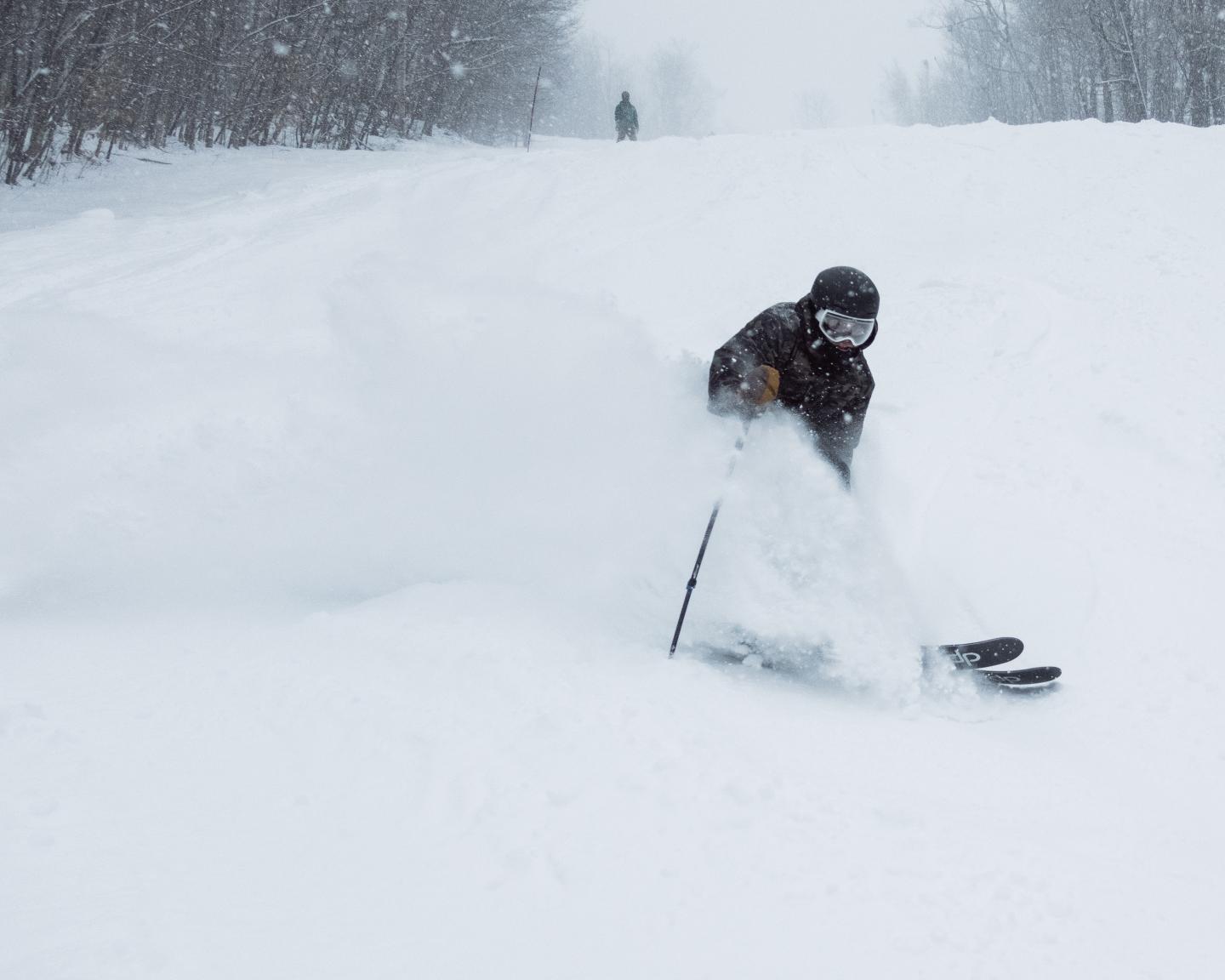 skier slashing powder