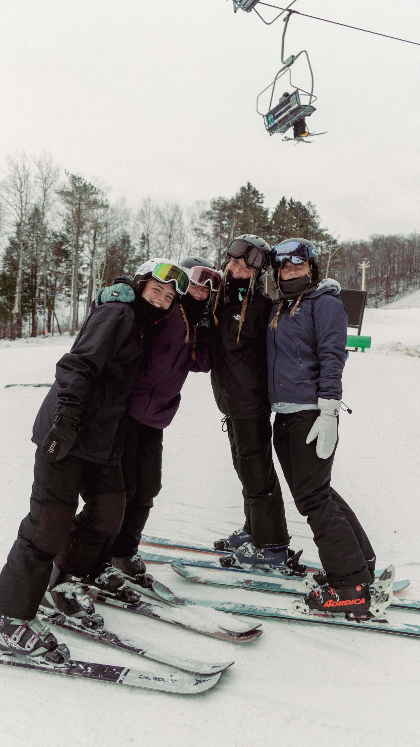 Bousquet Mountain snowboarders under lift