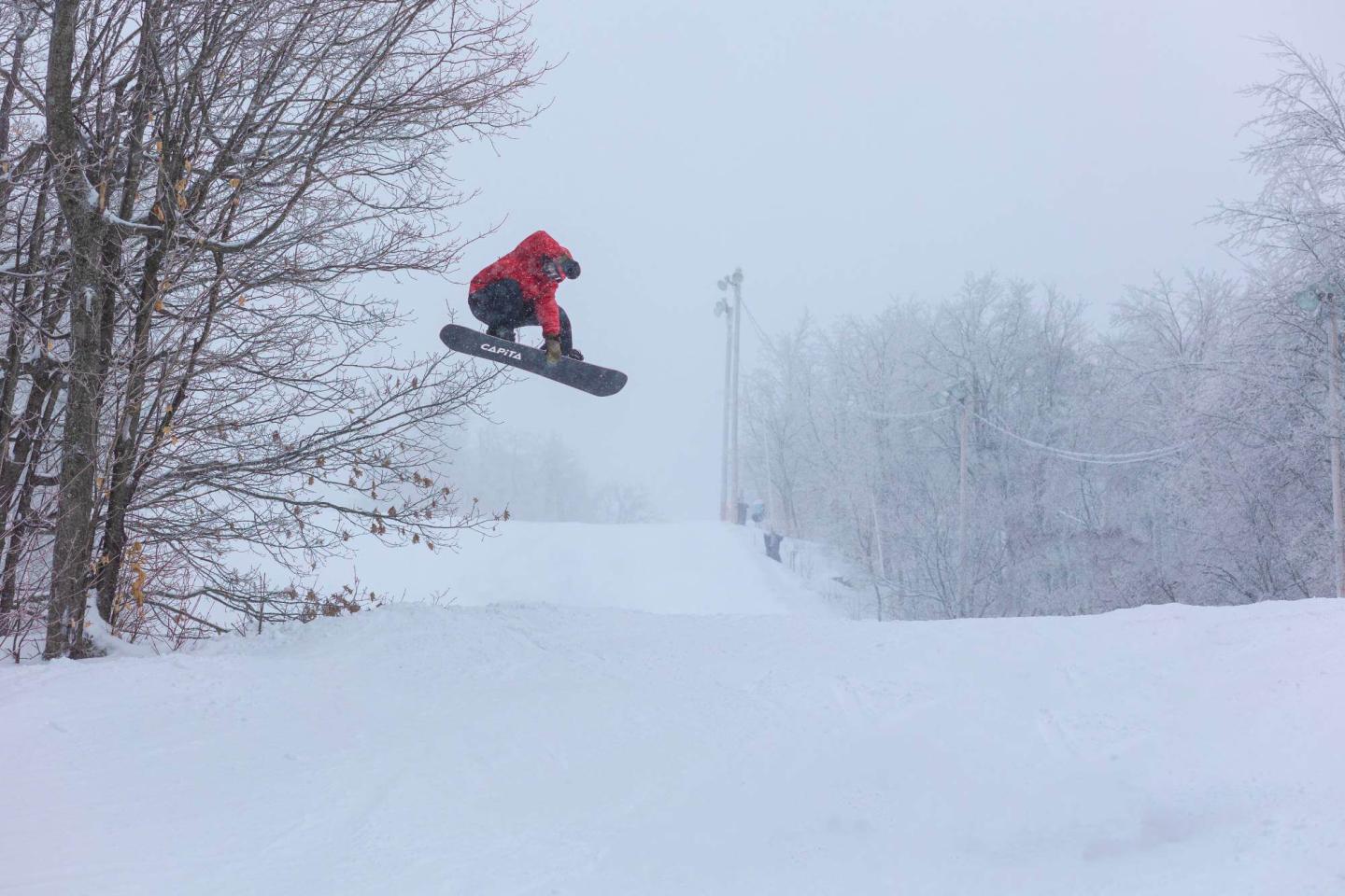 Camp Fortune snowboarder jumping