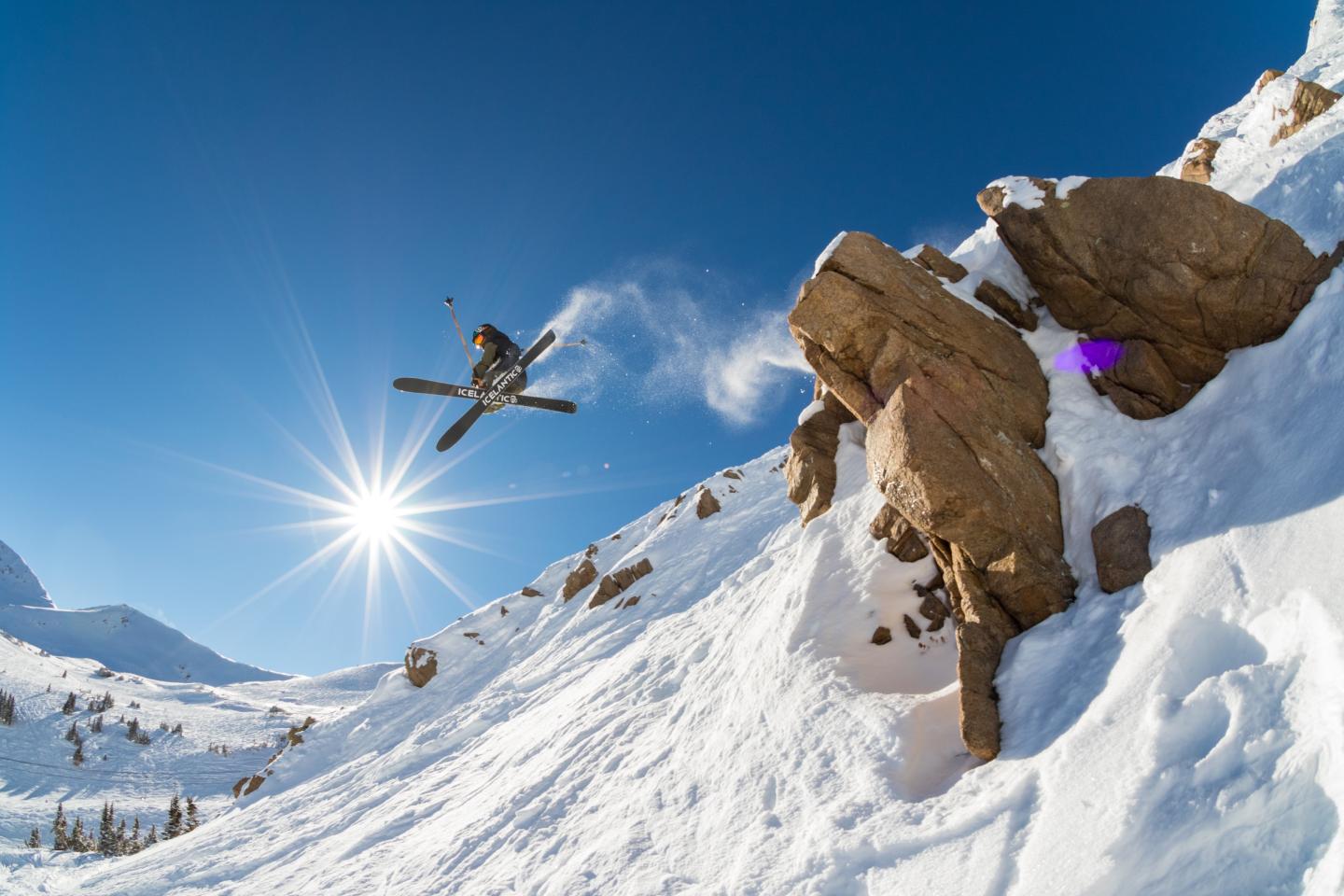 skier launching off cliff