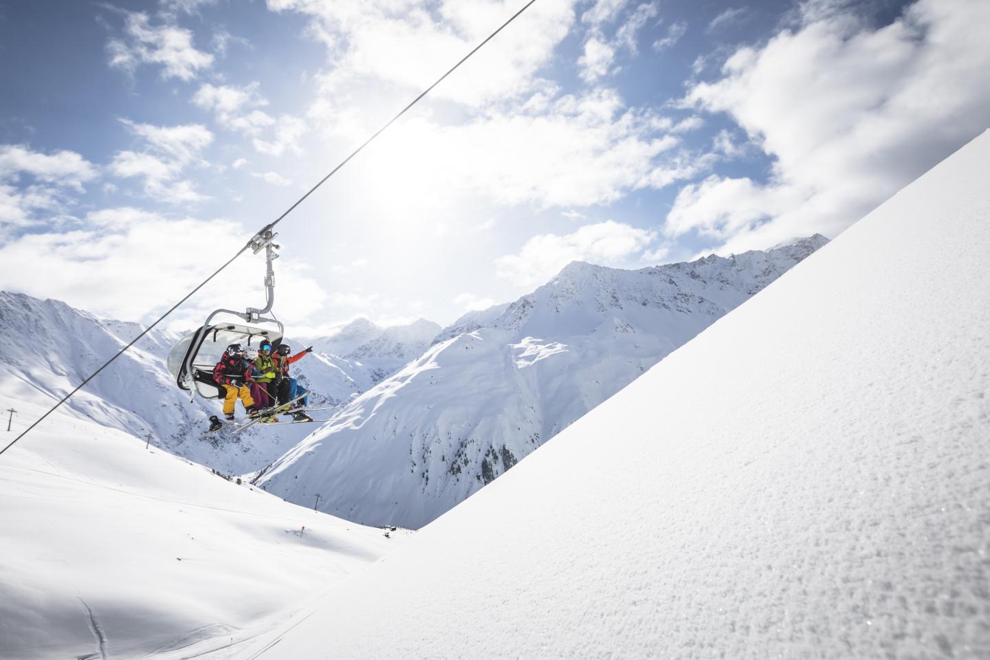skiers on a ski lift