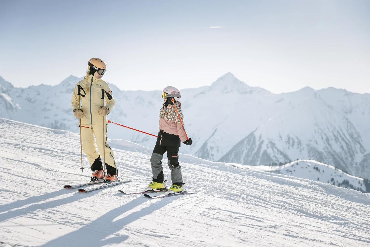 two people smiling on top of the mountain