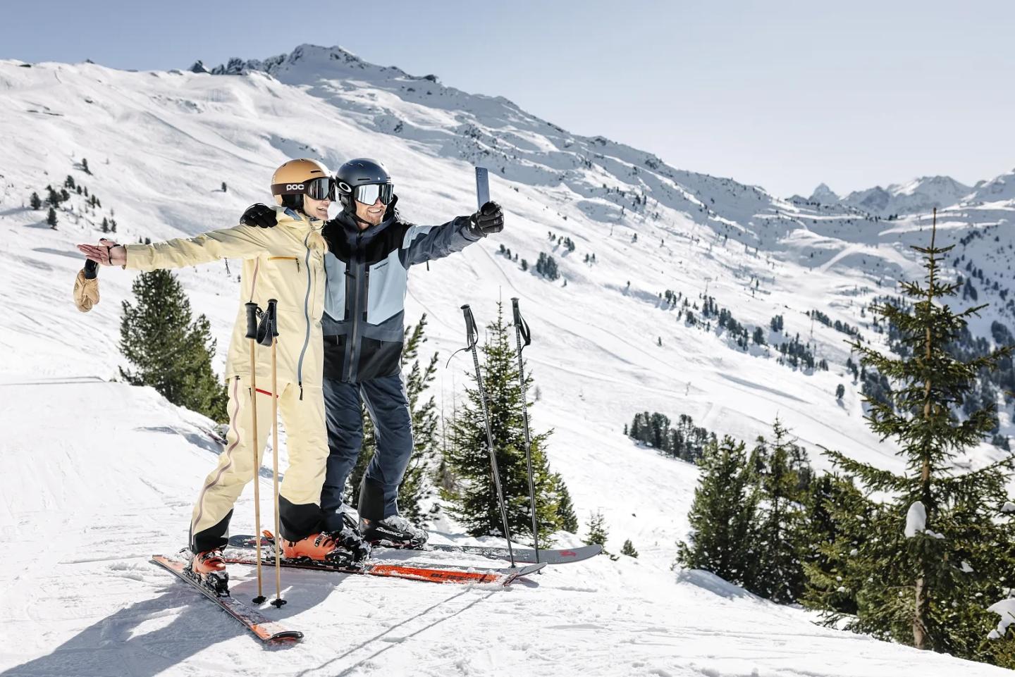 two skiers taking photo on the slopes