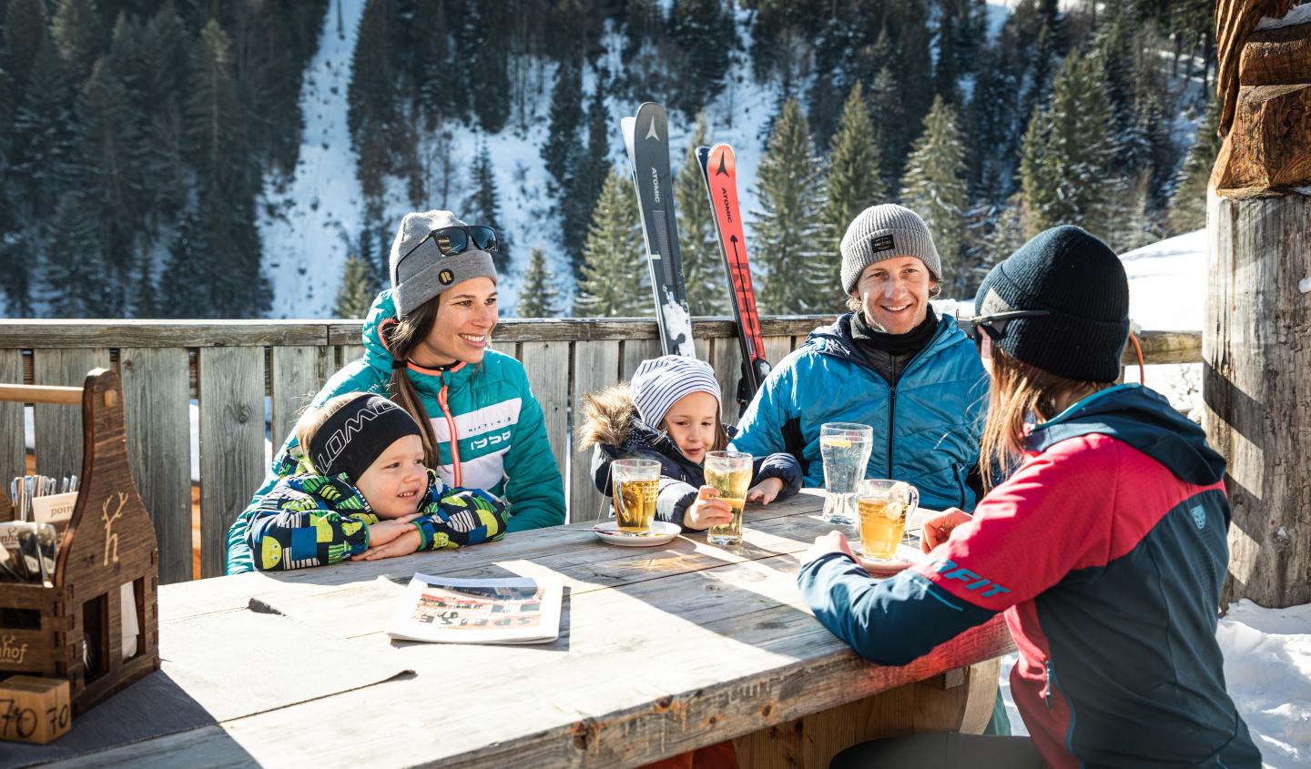 a family enjoying a meal at St. Johanner Bergbahnen 