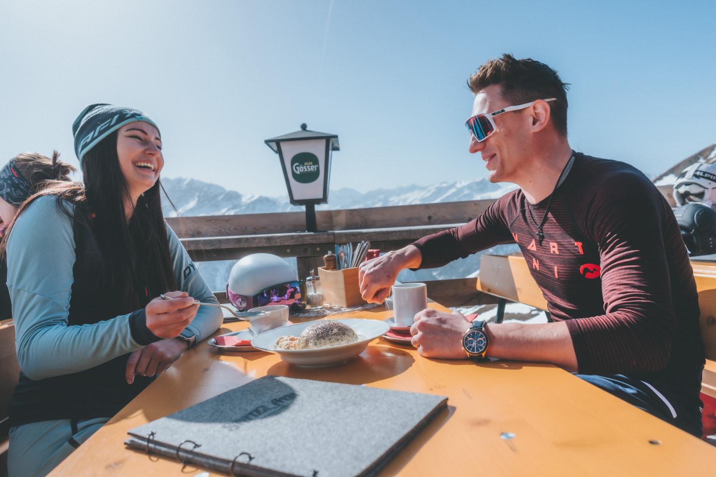 couple enjoying drinks and a meal at Heiligenblut - Grossglockner