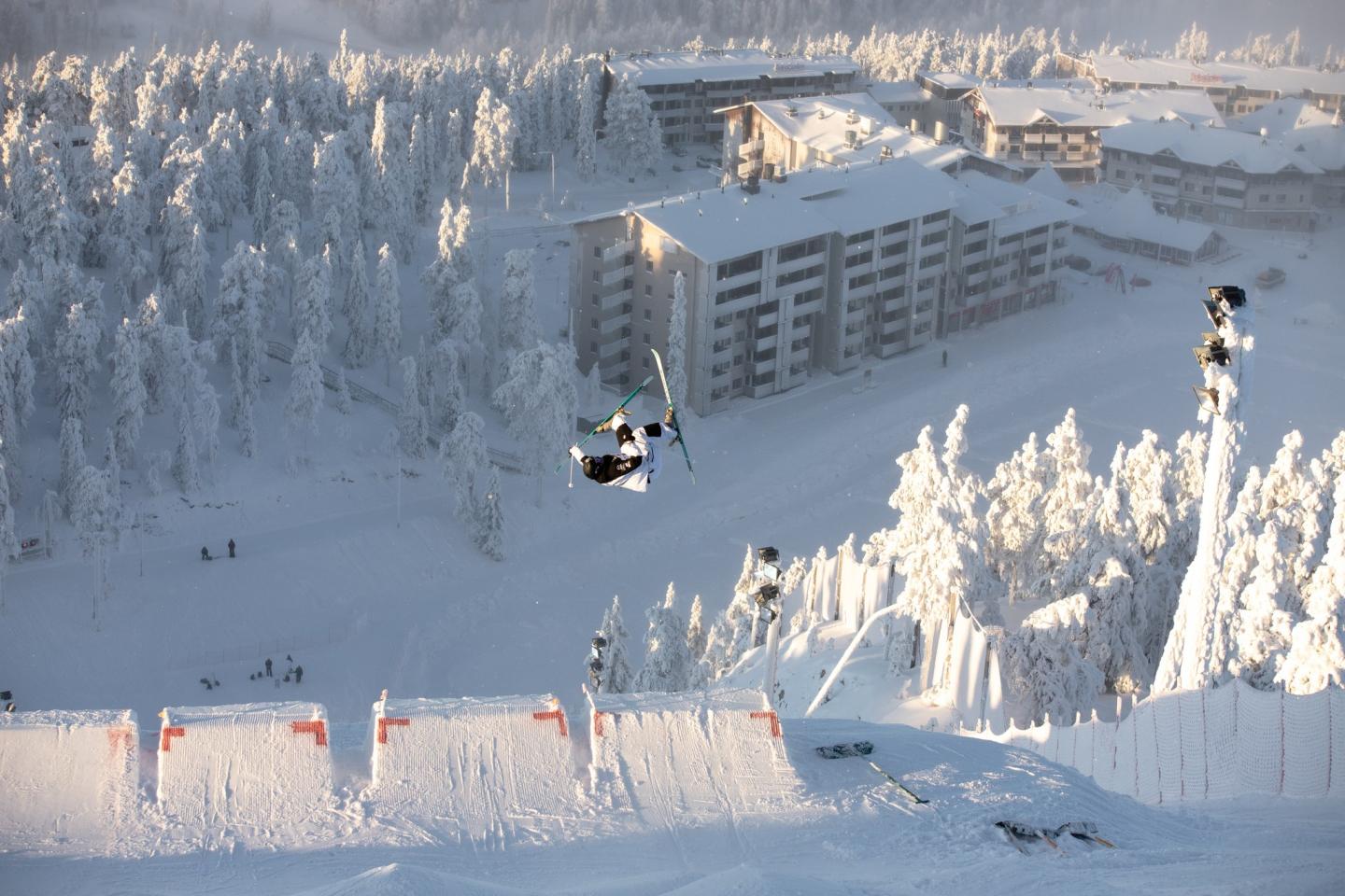 skier jumping over the hotels at Ruka