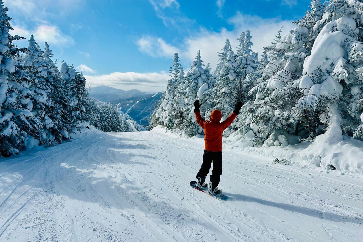 snowboarder with their hands in the air at Smugglers Notch Resort