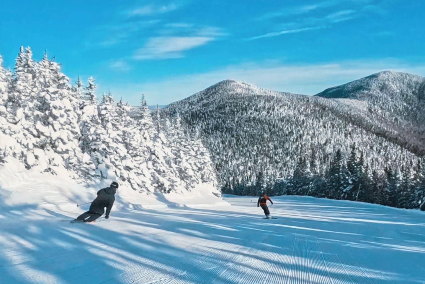 two people skiing and snowboarding at Smugglers Notch Resort
