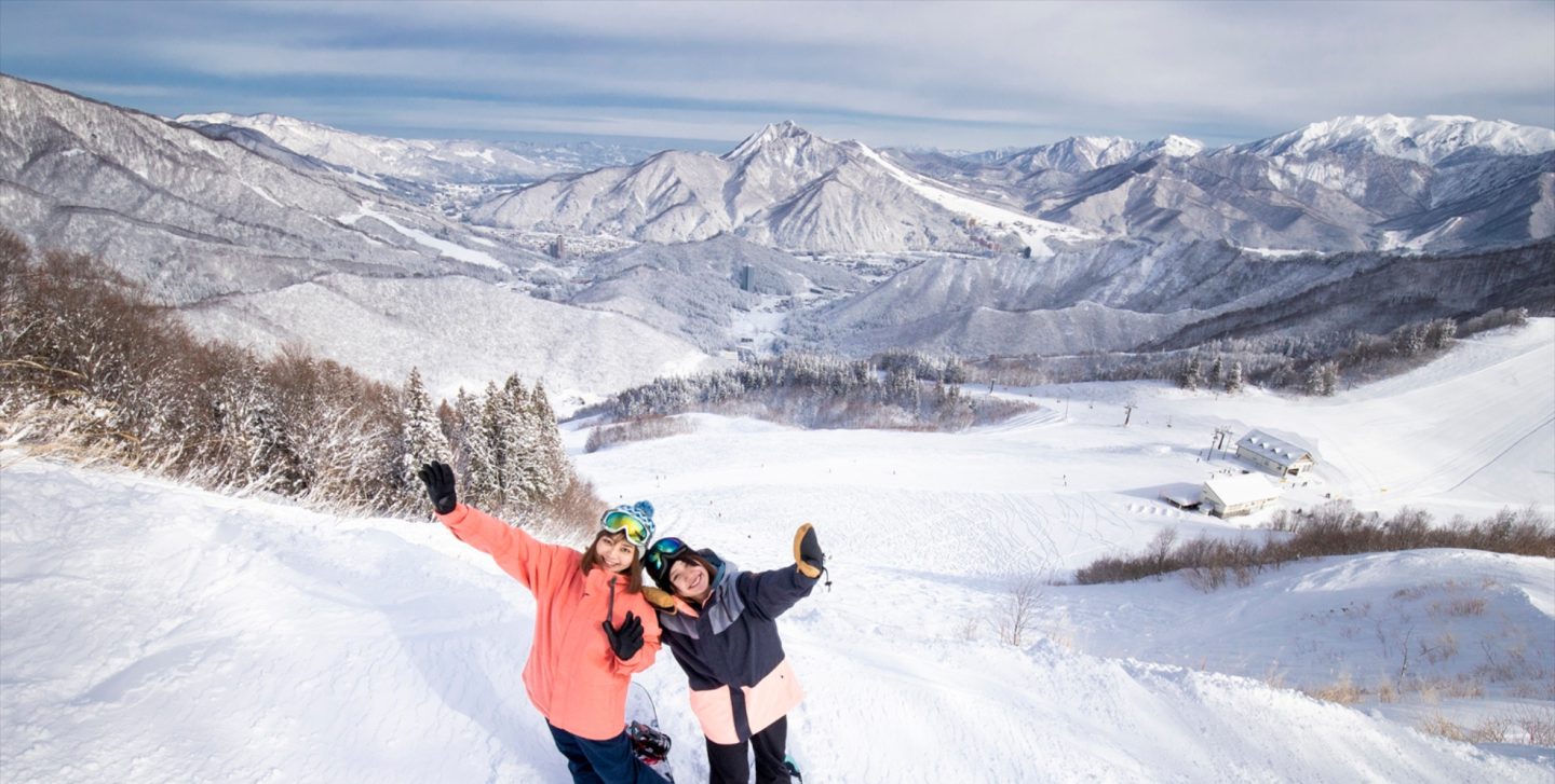 Two girls snowboarding at Kandatsu Snow Resort, Japan