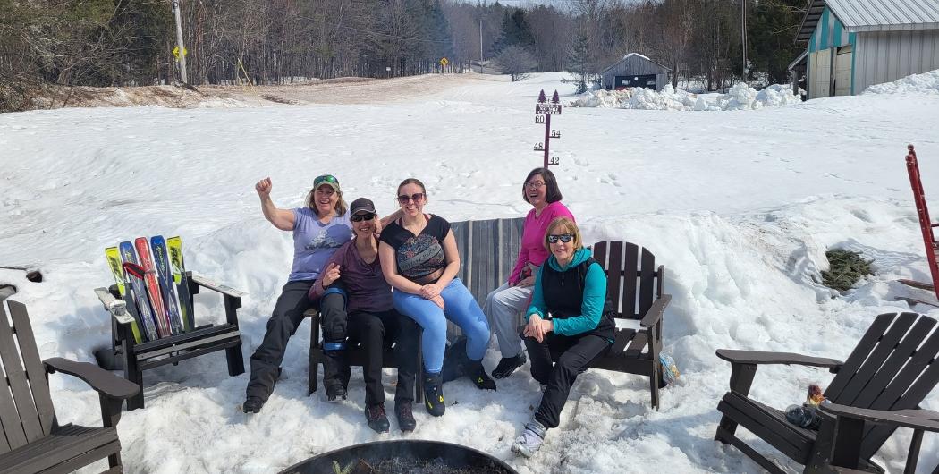 group of friends enjoying the fire pits at Osceola Tug Hill
