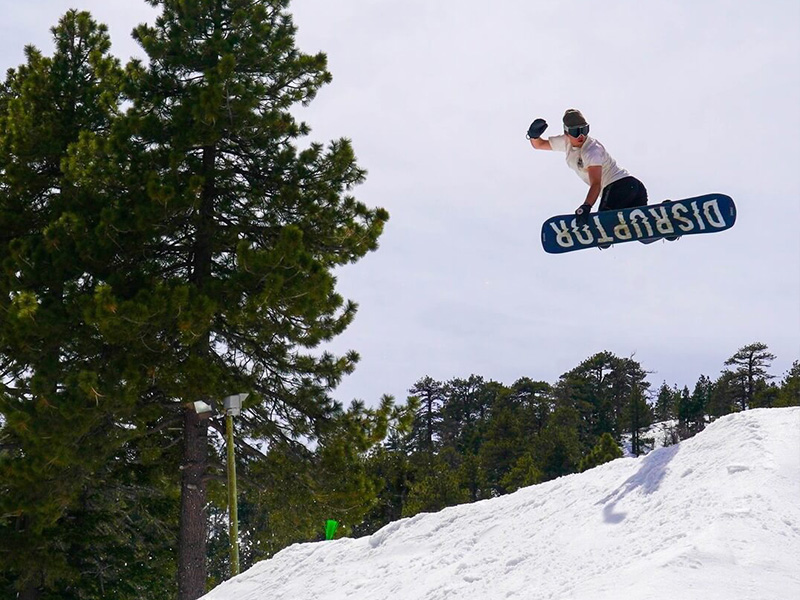 Snowboarder doing a method trick at Mountain High, CA